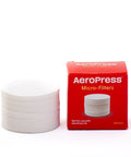 A box of AeroPress filters next to a stack of AeroPress filters.