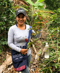 María Perez, a staff member from Sol y Café, in a coffee field. 